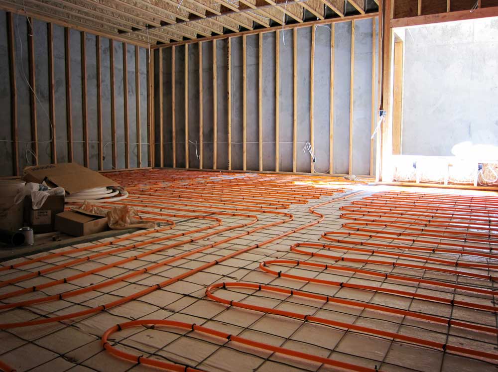 Hydronic radiant-heating tubing laid across a floor before the finished surface