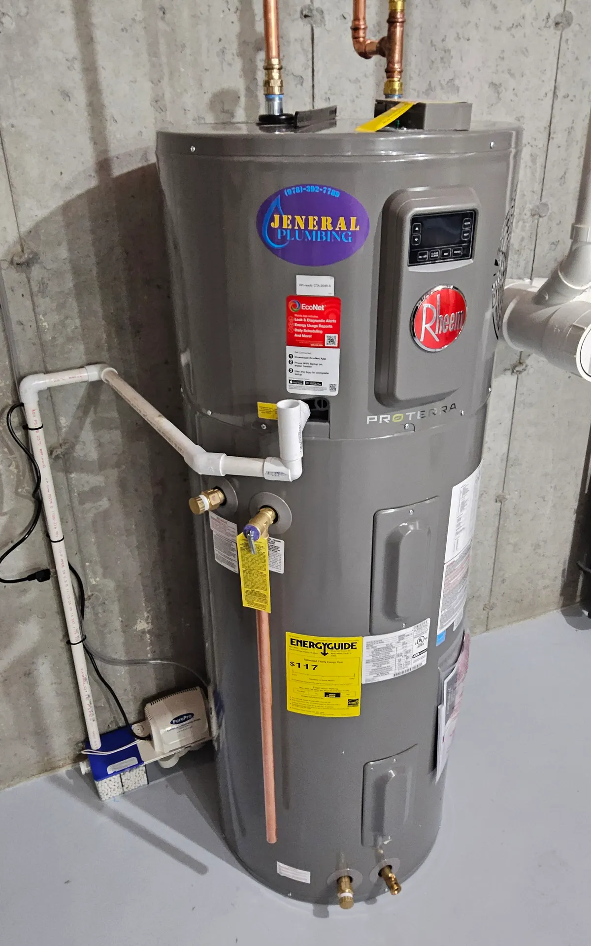 Rheem ProTerra hybrid heat pump water heater with condensate pump installed by Jeneral Plumbing in a Massachusetts basement